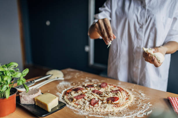 istock A woman prepares a pizza 1551310636