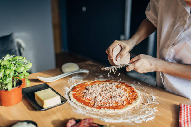 istock A woman prepares a pizza 1551311166