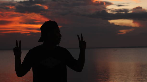 silhouette of man on the lake