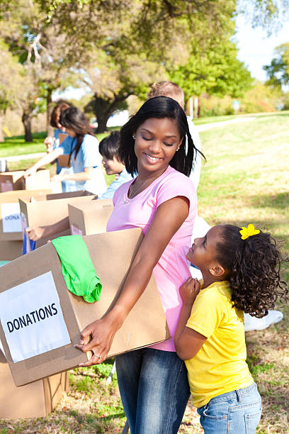 istock Happy woman with her daughter handling donations 155132189