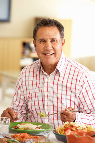 istock Senior Hispanic Man Enjoying Meal At Home 155132199