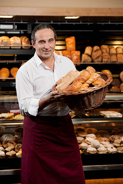 istock Baker holding basket with various kind of bread 155132422