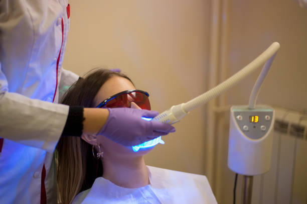 istock Dentistry dentist working teeth whitening dental medical process 1551325837