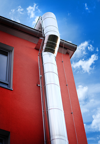 a chimney sticking out of an iron-clad roof. High quality photo