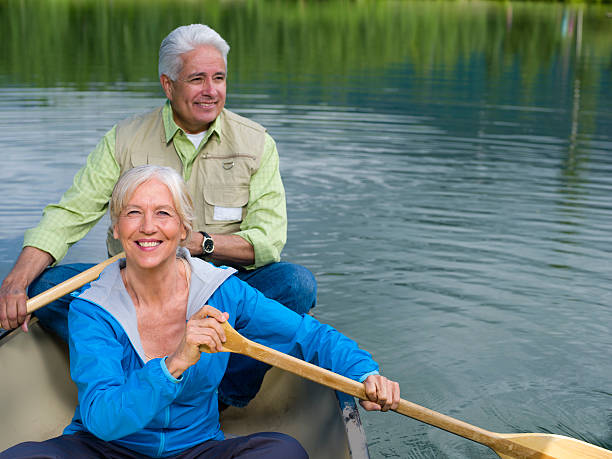 coppia senior - canoeing canoe senior adult couple foto e immagini stock