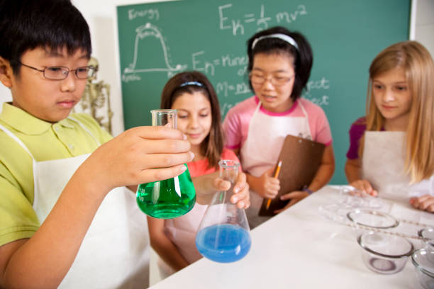 istock Students, children chemistry lab mixing chemicals. Science classroom, school, education. 155133472