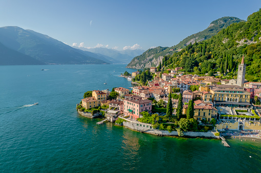 Varenna, Como Lake. Aerial panoramic view of town surrounded by mountains, blue sky and turquoise water and located in Como Lake, Lombardy, Italy