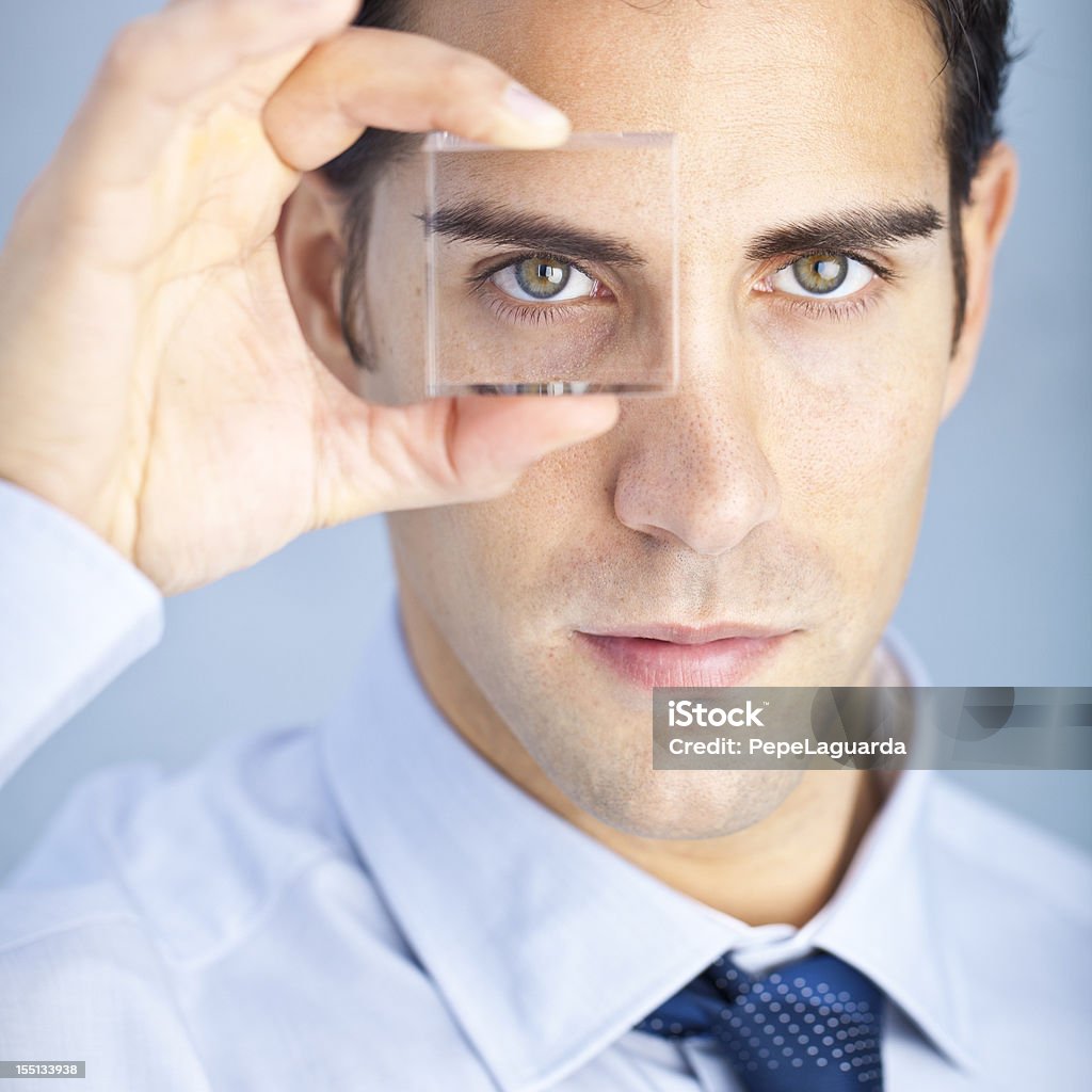 Business vision: looking through a lens Business vision: looking through a squared lens. Holding Stock Photo