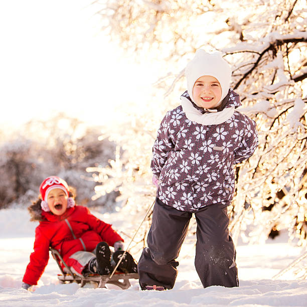 Two Little Girls Having Fun in Winter Park stock photo