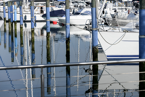 Dock pier harbor reflecting calm water at sea leisure high quality white yachts and boats concept water sports boating chipping and vacations