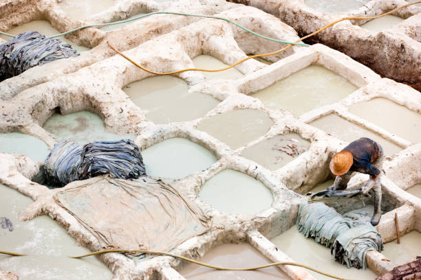istock Worker at Fez Medina Tannery Fes, Morocco 155134855