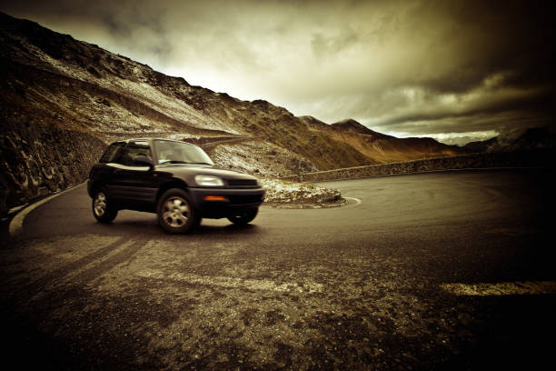 Car Driving on a Mountain Road, Dramatic Sky, Roadtrip Travel