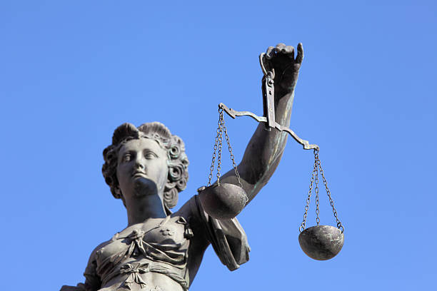 istock half portrait of Lady Justice against blue sky 155135507