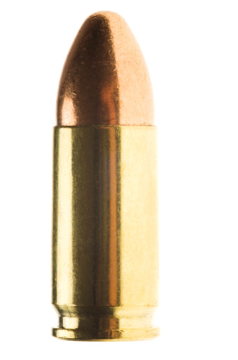 Close-up of a 9mm full metal jacket bullet isolated on white background with reflection.