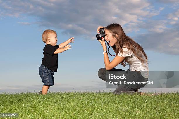 Mother Taking Pictures Of Walking Child Outdoors Stock Photo - Download Image Now - 12-17 Months, 18-23 Months, 20-29 Years