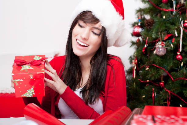 istock Smiling female holding christmas gift 155136325