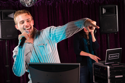 A young man singing karaoke.