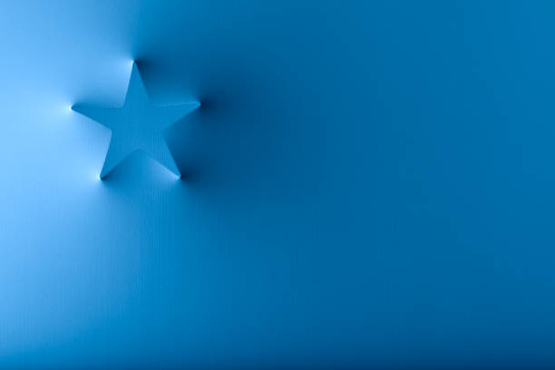 Christmas tree and star shape popping out from a white surface.