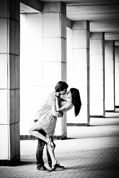 Photo of Young couple kissing in the passage