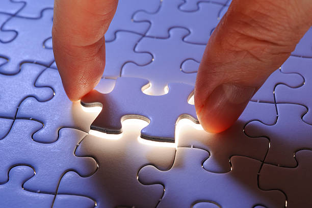 istock Holding a blue final piece of the jigsaw 155137266