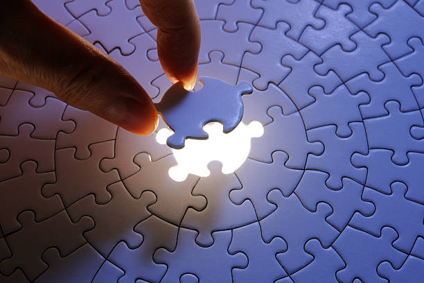istock Holding a blue final piece of the jigsaw 155137344
