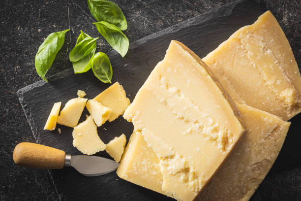 istock Tasty parmesan cheese on cutting board. 1551373732