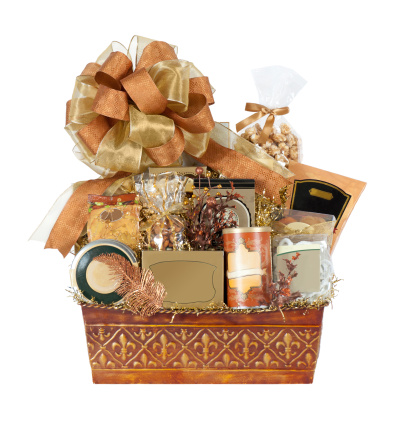 Beautiful gift basket filled with a variety of goodies.  Isolated on white.  