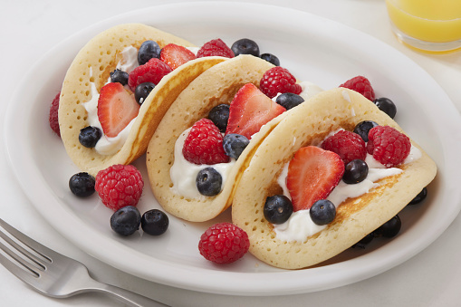 The Viral Pancake Breakfast Taco with Yogurt, Strawberry's, Raspberry's and Blueberries
