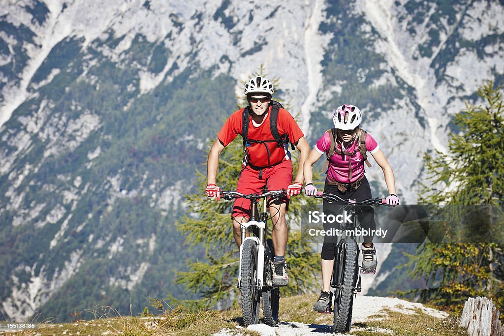 Couple on mountain bikes Couple of mountainbikers on the way up. 20-24 Years Stock Photo