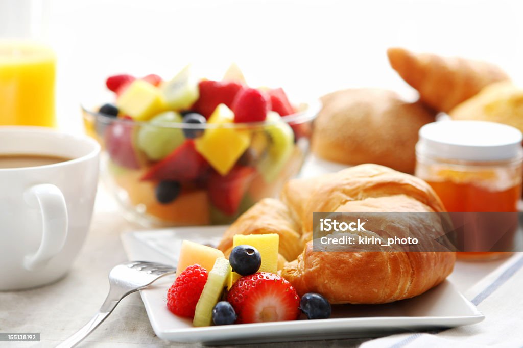 Breakfast of croissant, fruit salad, and coffee breakfast- croissant, fruit salad and coffee Continental Breakfast Stock Photo