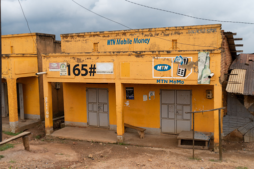 Nyamiaga, Uganda - March 23, 2023: A closed MTN Mobile Money telecommunications shop in a rural village market