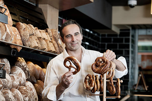 Salesman in a bakery with pretzels stock photo