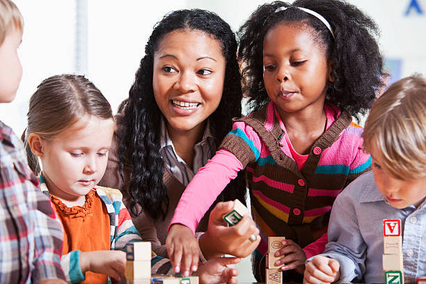 istock Preschool children in classroom with teacher 155138603