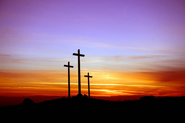 Three crosses standing at the sunset stock photo