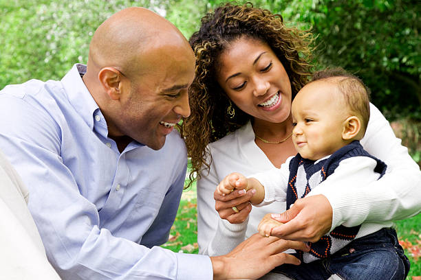 istock Parents engage their son in play on a sunny day 155138691