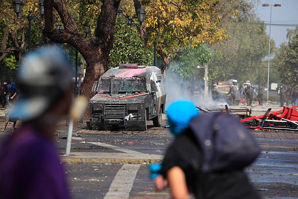 Demonstration in Chile A group of protesters causing damage on the street during a student strike in Santiago's Downtown, Chile. tear gas photos stock pictures, royalty-free photos & images