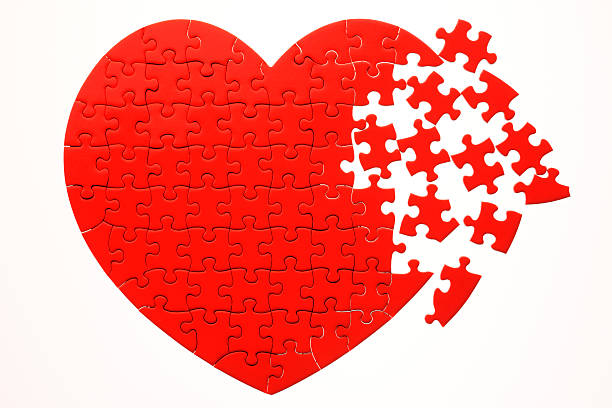 Broken red heart shape jigsaw puzzle isolated on white background.