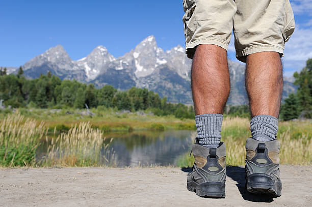 Hikers Legs Overlooking Mountain and River stock photo
