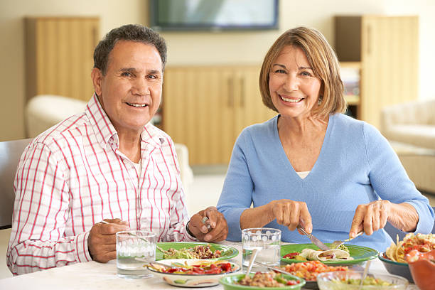istock Senior Hispanic Couple Enjoying Meal At Home 155139068