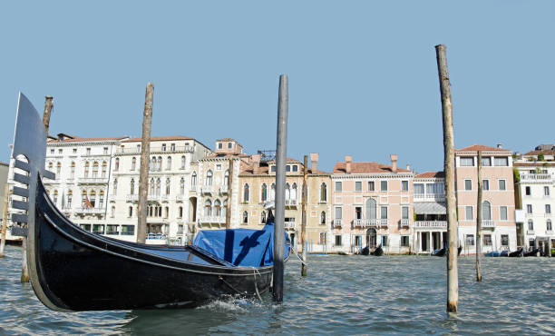 Over Grand Canal water, a Venice Gondoa tied to pilings... water level.