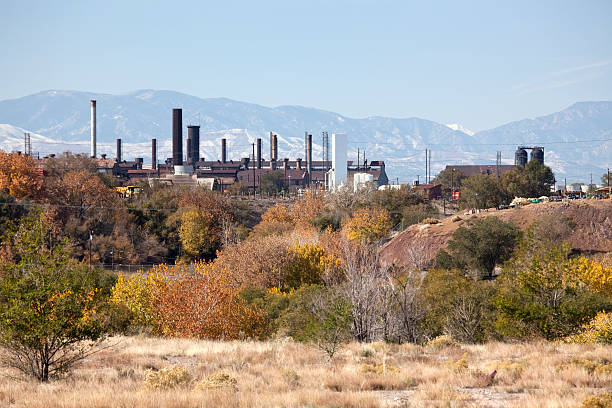 Fall colors with Pueblo's Colorado Steel Mill smoke stacks horizontal stock photo