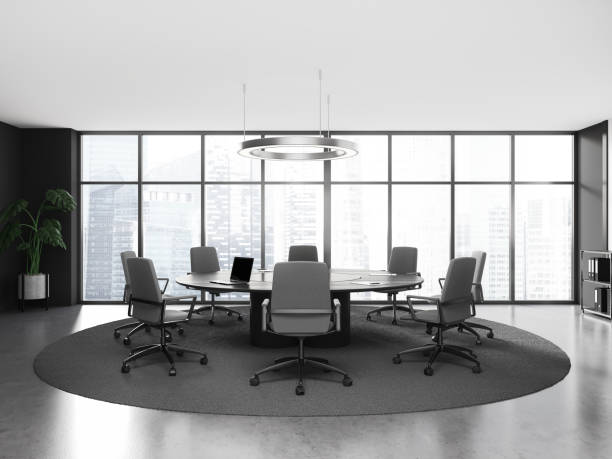 istock Stylish grey meeting room interior with table, armchairs and panoramic window 1551392263