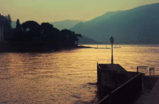 pier and mountains at Bellagio town located in the Como Lake - Italy