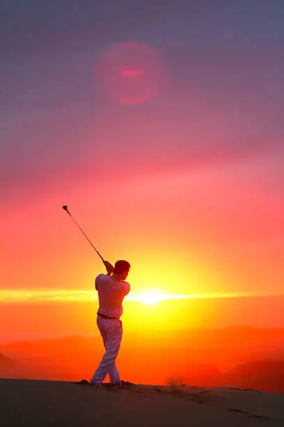 Photo of Golfer on a hill overlooking the pacific ocean in California