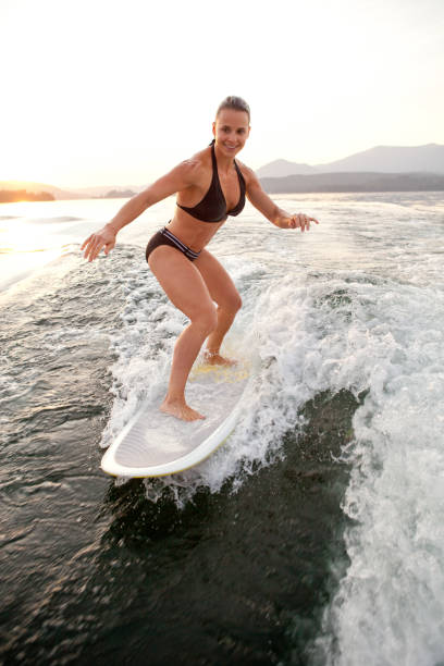 istock Girl in bikini wake surfing 155139668