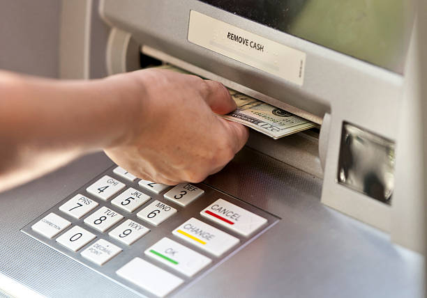 Getting the cash caucasian female hand picking the cash from an ATM atm photos stock pictures, royalty-free photos & images