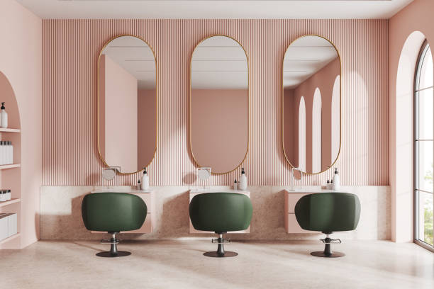 istock Pink cozy beauty salon with chairs in row and mirror, panoramic window 1551398086