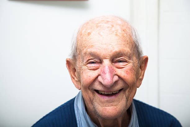 Cheerful ninety year old senior man in his house stock photo