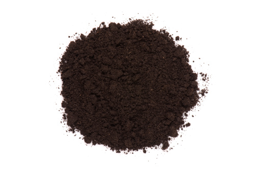 Pile of black dirt isolated on white. Gardening image. 