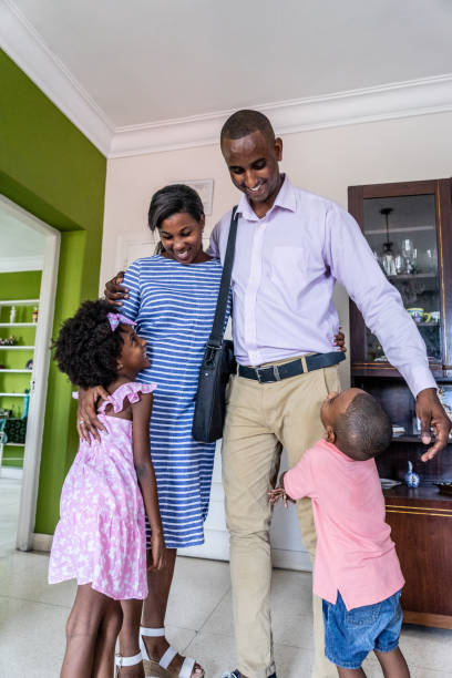 istock Happy family embracing at home 1551410216